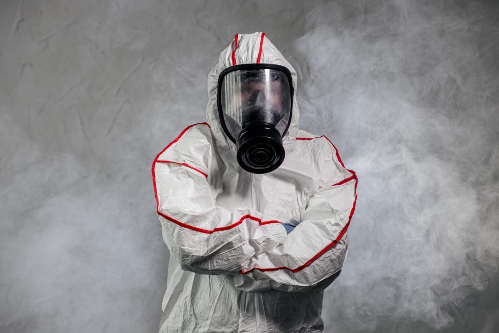 Person in hazmat suit with gas mask