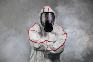 Person in hazmat suit with gas mask